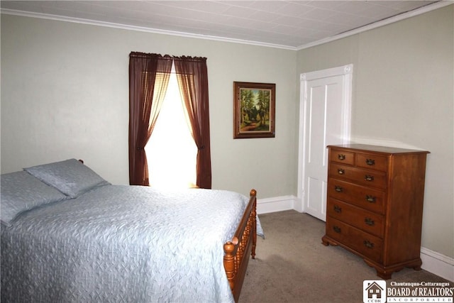 bedroom with carpet floors, crown molding, and baseboards