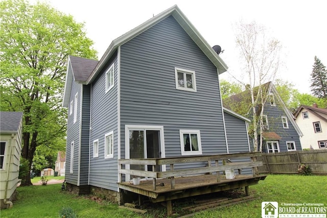 rear view of property featuring a wooden deck