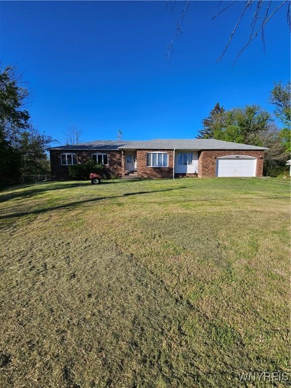 3159 Upper Mountain Rd, Cambria, NY 14132 - ranch-style house featuring an attached garage and a front yard