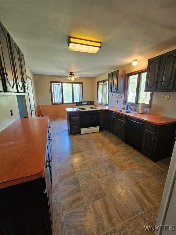 3159 Upper Mountain Rd, Cambria, NY 14132 - kitchen featuring electric range, dishwasher, a peninsula, and healthy amount of natural light
