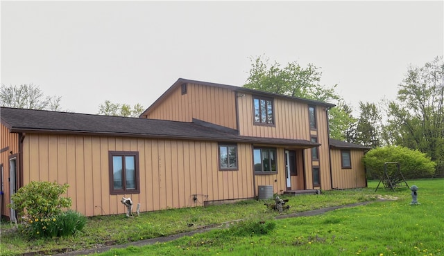 1142 W Ave, Clarkson, NY 14420 - rear view of property with a lawn, board and batten siding, and central AC