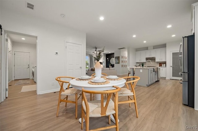 161 Knapps Knolle Rd, Schuyler, NY 13502 - dining room featuring baseboards, light wood-style floors, recessed lighting, and washing machine and clothes dryer