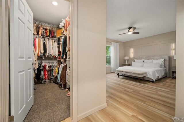 161 Knapps Knolle Rd, Schuyler, NY 13502 - bedroom with a closet, a spacious closet, wood finished floors, ceiling fan, and baseboards