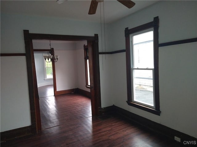 406 Milton Ave, Syracuse, NY 13204 - spare room with a chandelier, dark wood-type flooring, a ceiling fan, and baseboards