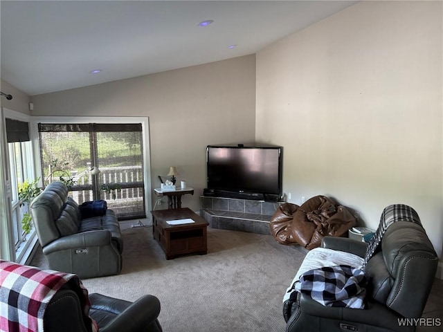 living area featuring lofted ceiling and carpet floors