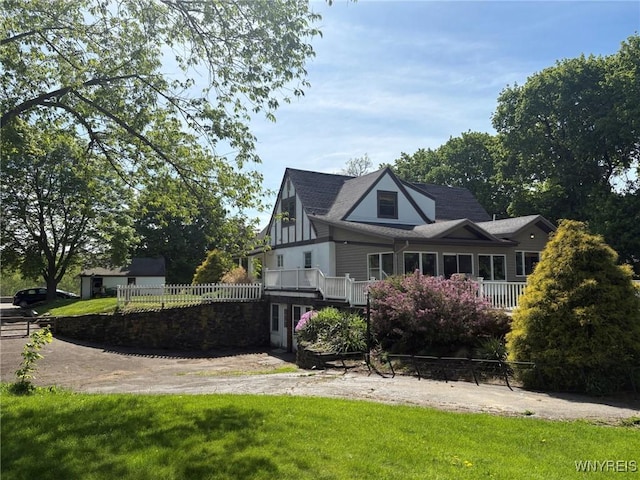 view of side of home with a shingled roof