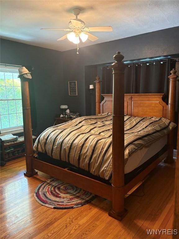 bedroom with wood finished floors and a ceiling fan