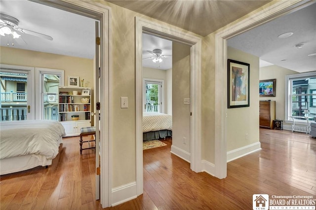 14 S Lake Dr Unit 2B, Chautauqua, NY 14722 - bedroom with hardwood / wood-style flooring, baseboards, and multiple windows