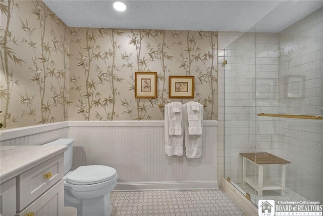 14 S Lake Dr Unit 2B, Chautauqua, NY 14722 - bathroom featuring toilet, a wainscoted wall, a tile shower, tile patterned floors, and vanity