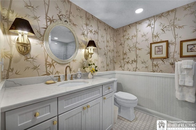 14 S Lake Dr Unit 2B, Chautauqua, NY 14722 - bathroom with a wainscoted wall, toilet, vanity, wallpapered walls, and recessed lighting