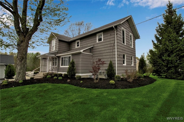 view of side of home featuring a yard