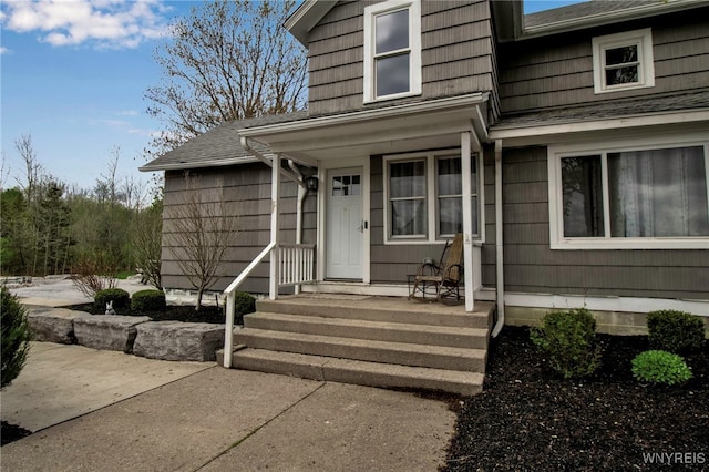 entrance to property with a shingled roof