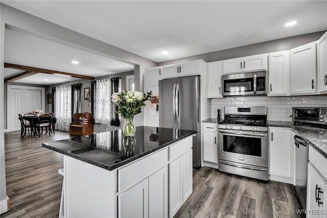 kitchen featuring stainless steel appliances, dark wood finished floors, white cabinetry, and recessed lighting