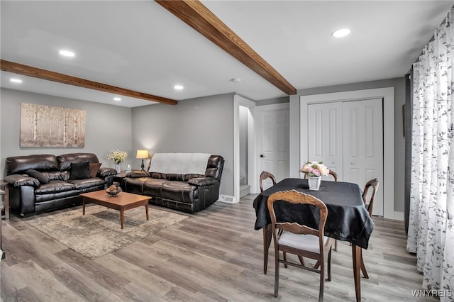 living room featuring recessed lighting, beamed ceiling, light wood finished floors, and baseboards