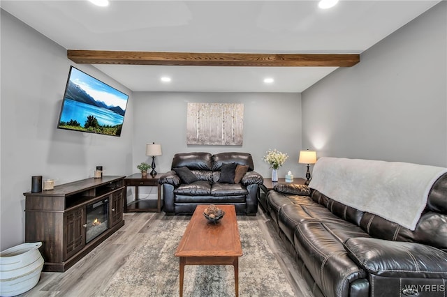 living area with light wood finished floors, beamed ceiling, and recessed lighting