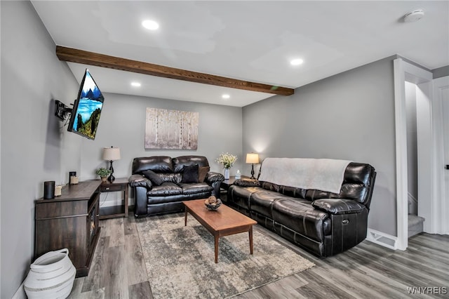 living room featuring wood finished floors, beamed ceiling, recessed lighting, stairway, and baseboards