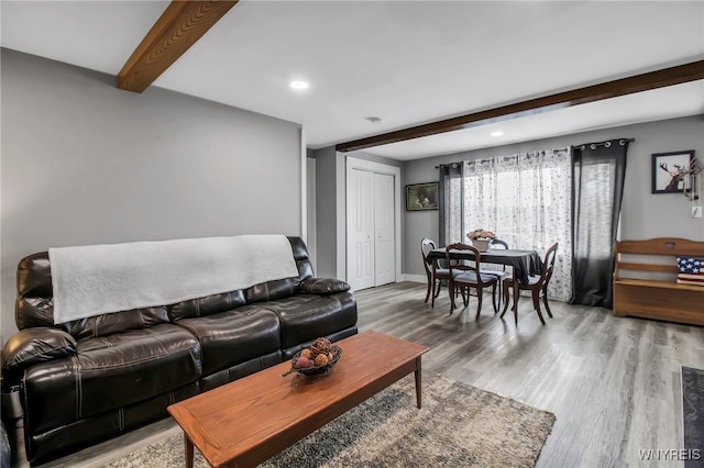 living room with beamed ceiling, wood finished floors, recessed lighting, and baseboards
