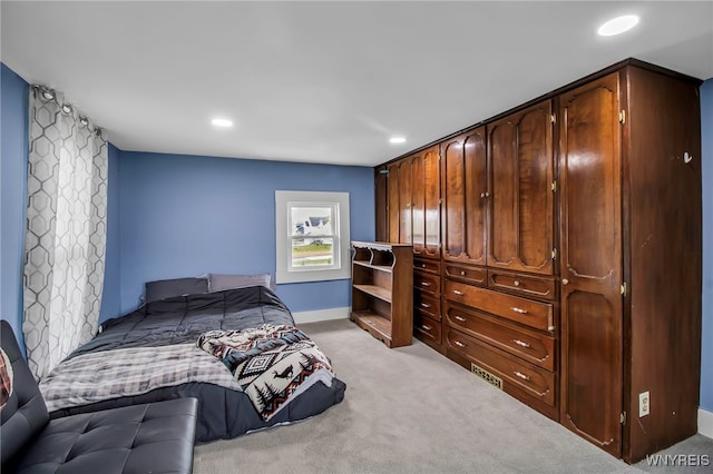bedroom featuring light carpet, recessed lighting, and baseboards