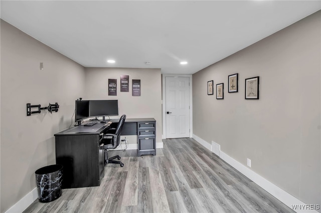 office space featuring light wood finished floors, baseboards, and recessed lighting