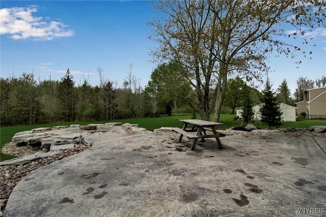 view of community with a lawn and a patio