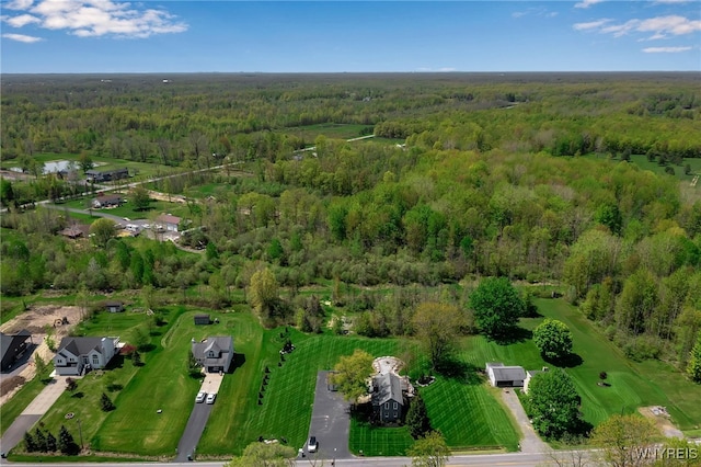 aerial view of property's location featuring a heavily wooded area