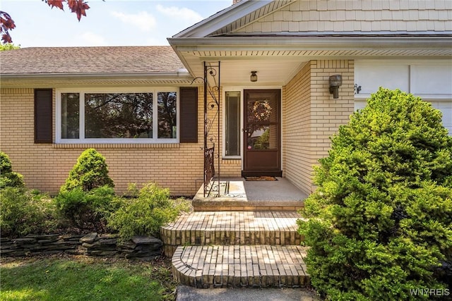 property entrance with brick siding and covered porch