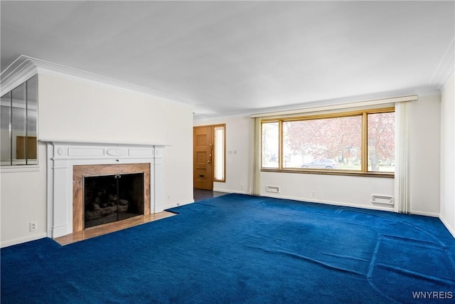 unfurnished living room featuring a fireplace with flush hearth, crown molding, carpet, and baseboards