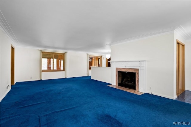 unfurnished living room with ornamental molding, a high end fireplace, baseboards, and carpet flooring