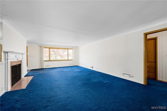 unfurnished living room with a fireplace with flush hearth, ornamental molding, and carpet flooring