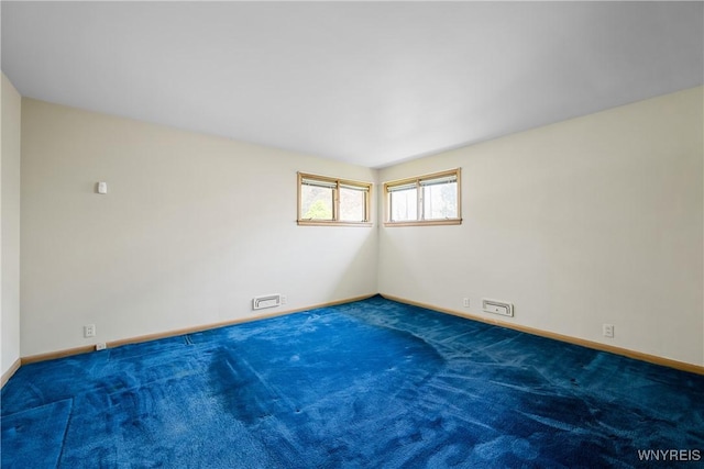 carpeted empty room with baseboards