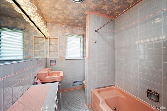 bathroom featuring plenty of natural light, shower / washtub combination, tile walls, toilet, and vanity