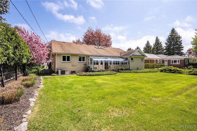 back of house with brick siding and central AC