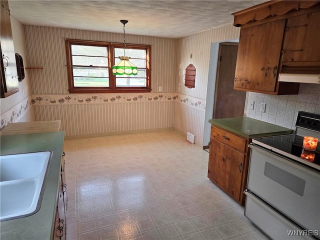 585 Downing St, Buffalo, NY 14220 - kitchen featuring white electric range oven, wallpapered walls, brown cabinetry, light floors, and exhaust hood