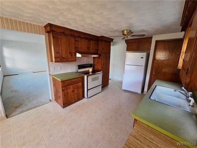 585 Downing St, Buffalo, NY 14220 - kitchen with white appliances, a ceiling fan, light flooring, under cabinet range hood, and brown cabinetry