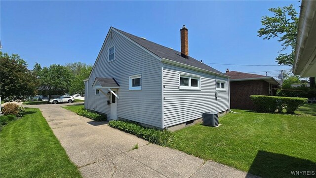 585 Downing St, Buffalo, NY 14220 - view of side of property with a yard and a chimney
