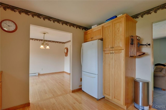 43 County Rte 9, Rossie, NY 13642 - kitchen featuring freestanding refrigerator, a baseboard radiator, light wood-type flooring, a chandelier, and light brown cabinetry