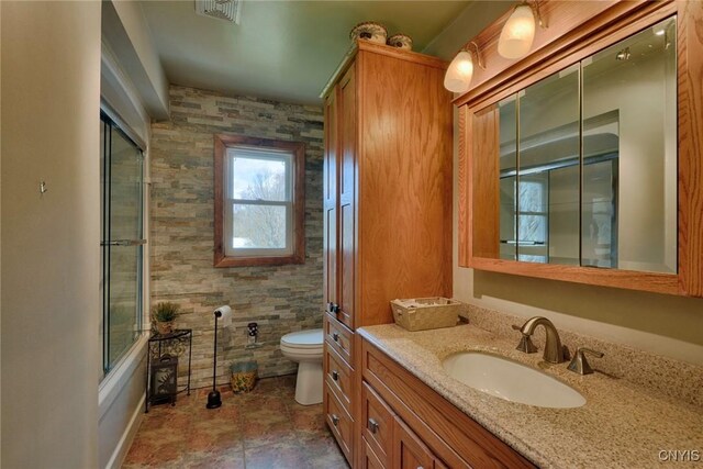 43 County Rte 9, Rossie, NY 13642 - bathroom with toilet, vanity, and bath / shower combo with glass door