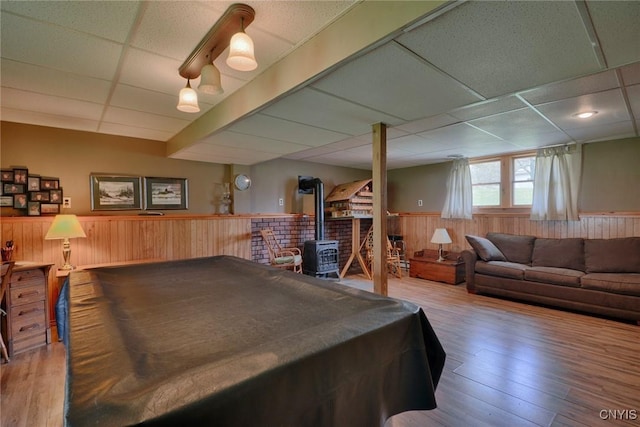 43 County Rte 9, Rossie, NY 13642 - playroom with a wainscoted wall, wood walls, a wood stove, a drop ceiling, and wood finished floors