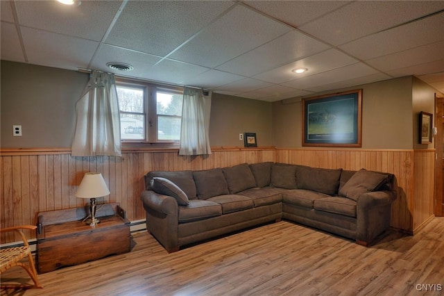 43 County Rte 9, Rossie, NY 13642 - living area featuring wainscoting, a paneled ceiling, wooden walls, wood finished floors, and baseboard heating