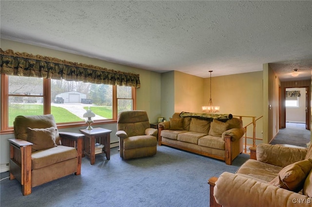 43 County Rte 9, Rossie, NY 13642 - carpeted living room with a textured ceiling and a chandelier
