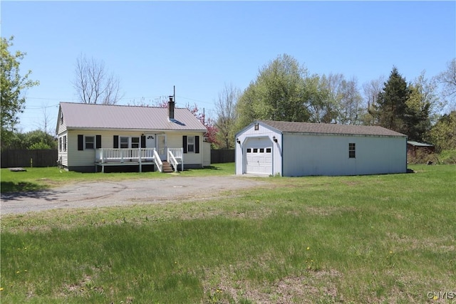 28139 US Route 11, Le Ray, NY 13637 - view of front of property featuring driveway, an outdoor structure, a detached garage, metal roof, and a wooden deck