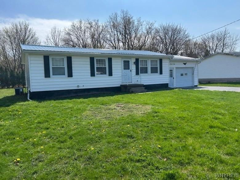 8484 E Ave, Royalton, NY 14067 - view of front of property featuring an attached garage, metal roof, concrete driveway, and a front lawn