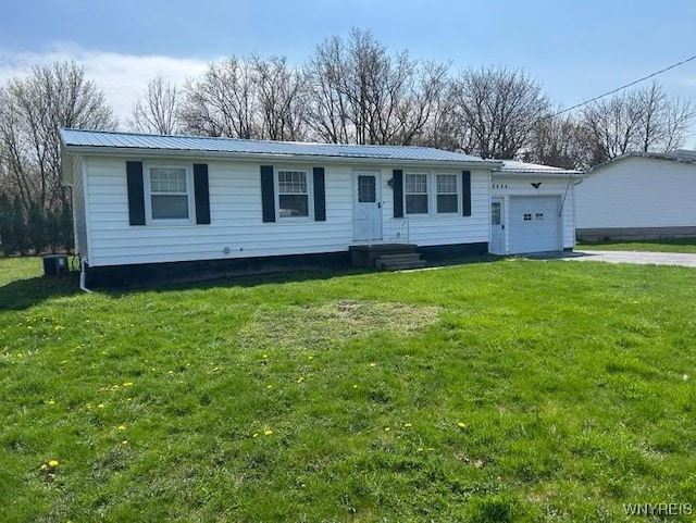 8484 E Ave, Royalton, NY 14067 - view of front of property featuring an attached garage, metal roof, concrete driveway, and a front lawn