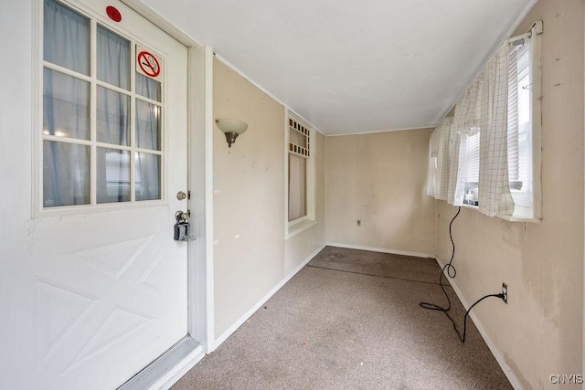 spare room featuring carpet floors and baseboards