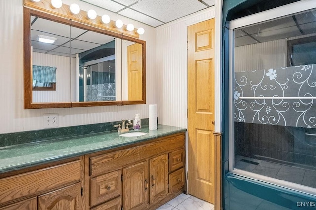 full bath with a paneled ceiling, a walk in shower, and vanity