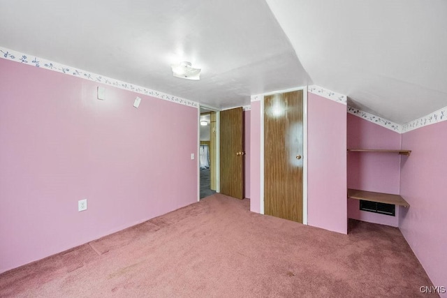 additional living space with carpet flooring and lofted ceiling