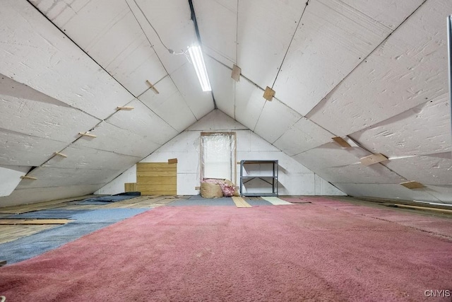 bonus room with vaulted ceiling and carpet