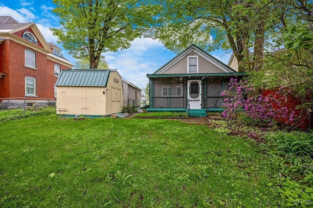 rear view of house with a storage shed and an outdoor structure