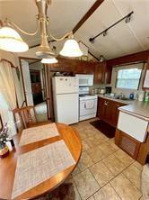 1984-2008 S Genesee St, Montour, NY 14865 - kitchen featuring white appliances, rail lighting, and lofted ceiling