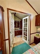 1984-2008 S Genesee St, Montour, NY 14865 - bedroom with vaulted ceiling, french doors, and light tile patterned flooring